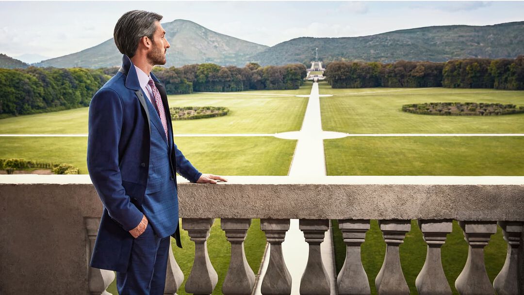 man on the terrace of a palace looking at the landscape